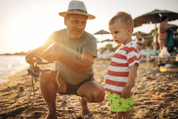 istock Fishing, grandfather teaches grandson to fish 1409876491