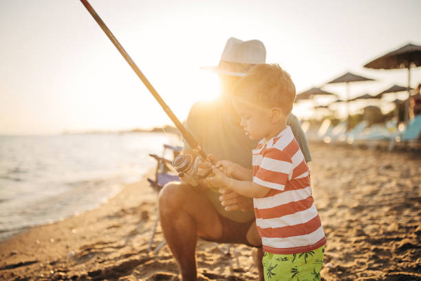 istock Fishing, grandfather teaches grandson to fish 1409876501