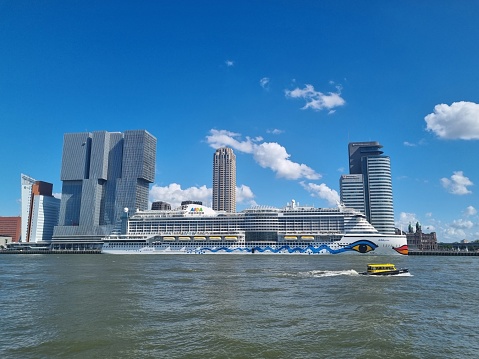 Skyline of Rotterdam with cruise ship and water taxi on river Meuse