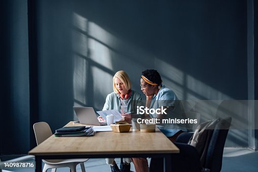 istock Two Friends Studying Together In The Library 1409878716