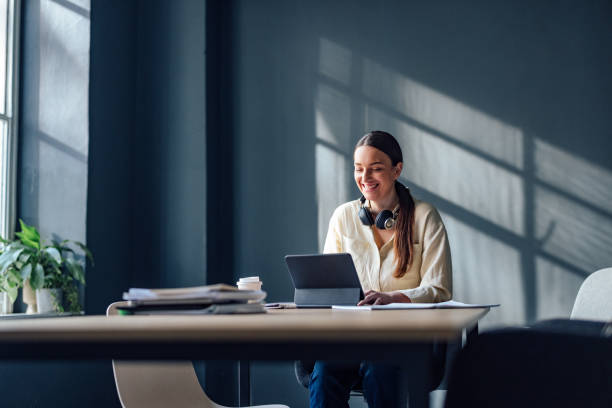 istock Smiling Female Student Studying Online On A Digital Tablet 1409878740