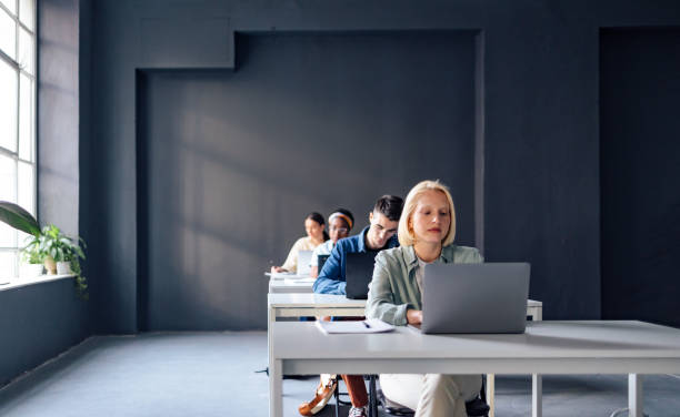 istock University Students Typing Notes On Laptop Keyboards While Sitting In The Classroom 1409878921