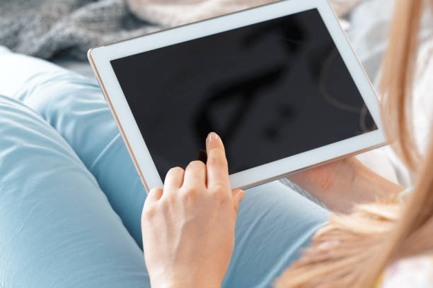 istock woman holding digital tablet, closeup 1409879255