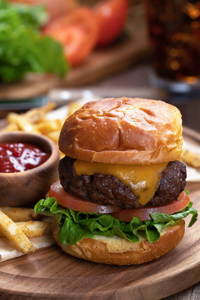 istock Cheeseburger with lettuce and tomato on toasted bun 1409882237