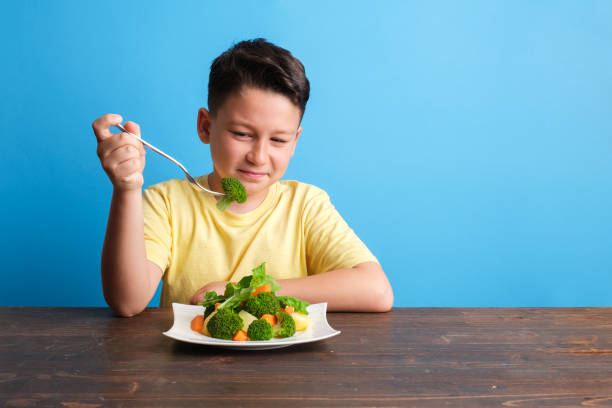 istock Child is very unhappy with having to eat vegetables 1409885285
