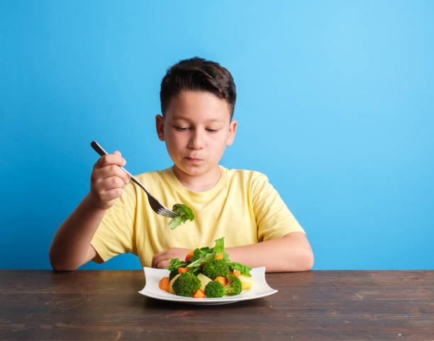 istock Child is very unhappy with having to eat vegetables 1409885345