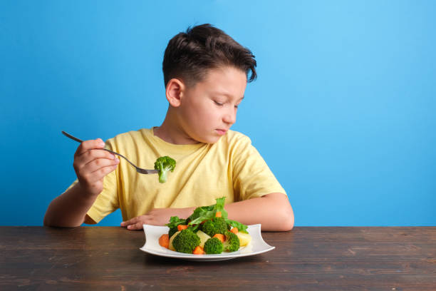 istock Child is very unhappy with having to eat vegetables 1409885504