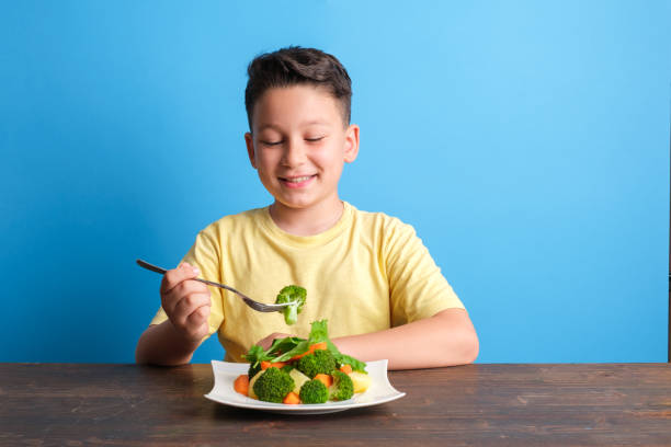 istock Child eating vegetables and happy 1409885606