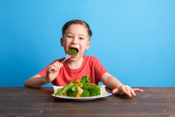 istock Child eating vegetables and happy 1409885767