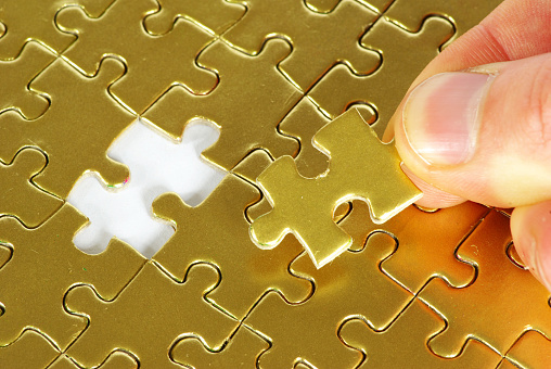 Incomplete blue jigsaw puzzle pieces on yellow background. Horizontal composition with copy space. Solution concept.