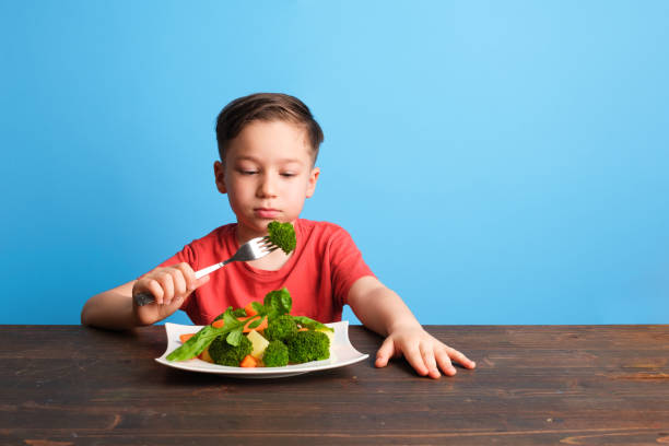 istock Child is very unhappy with having to eat vegetables 1409885794
