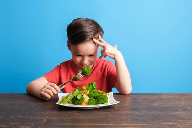 istock Child is very unhappy with having to eat vegetables 1409885944
