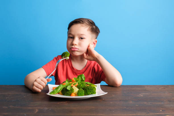 istock Child is very unhappy with having to eat vegetables 1409886032