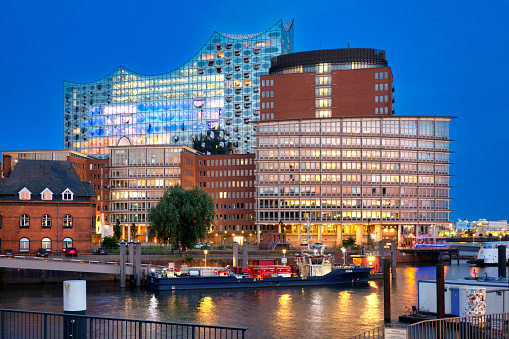 Hamburg, Germany July 19. 2022: View to Elbphilharmonie and Kehrwiederspitze at Hafencity, Hamburg at the blue hour