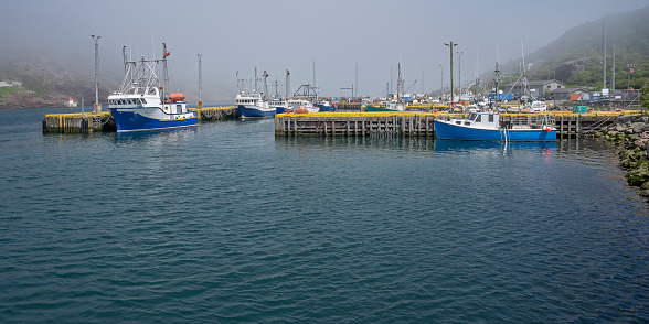 Fishing boats in fog at the St. John’s Harbour