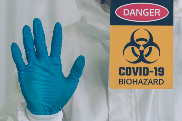 istock Lab Technician in Personal protective equipment  PPE suit Vaccines testing of Virus close-up 1409888311
