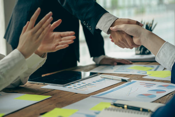 istock business people shake hands for business merger teamwork Say hello to the new team of colleagues. During the meeting to sign an agreement and become a successful business partner of both companies. 1409889727