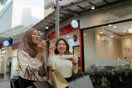 Multiracial group happy with shopping bags enjoying in shopping, having fun in the city.