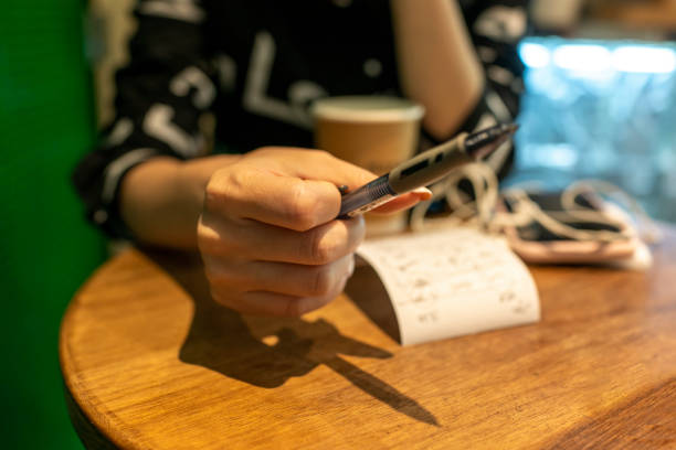 istock woman holding a pen 1409890290
