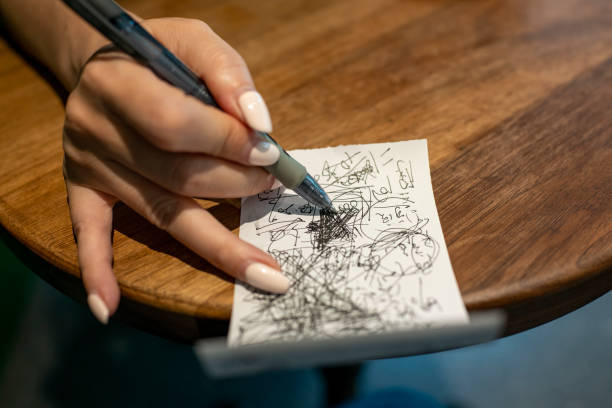 istock Woman is scribbling on paper with a pen 1409890302