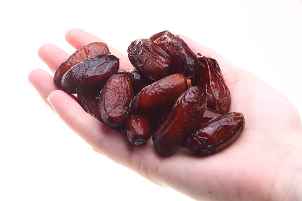 istock Dried date fruits in palm isolated 140989261