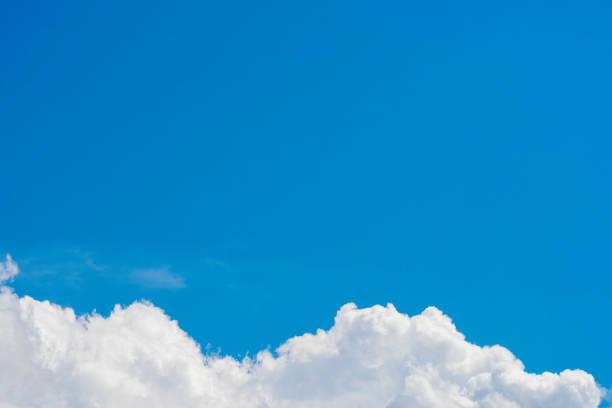 istock Background with a frame of white cumulus clouds and empty space for text on a blue background. 1409893147