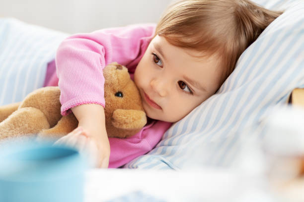 istock little girl lying in bed at home 1409894021