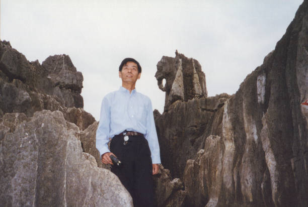 Group photo with elephant-like stones in Kunming Stone Forest, Yunnan Province, China