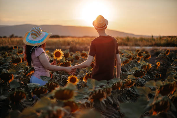 istock Young couple in sunflower field 1409896482