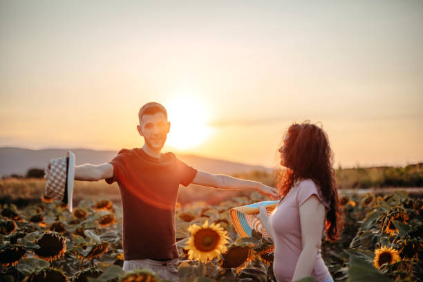 istock Young couple in sunflower field 1409897654