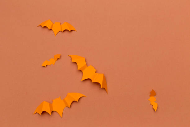 istock halloween and decoration concept - paper bats flying 1409898052