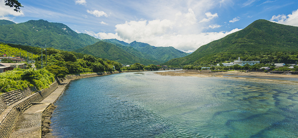 Panoramic views of the mountains, forests and river  in Yakushima viewed from the main bridge in Miyanoura. Yakushima is a small island in south Japan famous for it's ancient forests.