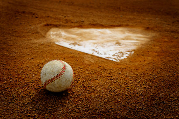 istock Old Leather Baseball on Field by Home Plate or Base 1409903201