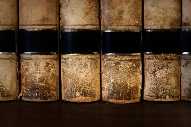 Old leather law books or lawbooks stacked on shelf