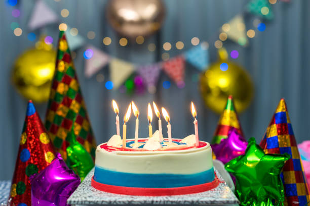 Birthday Cake and candle in party. Birthday cake with candles, bright lights bokeh. stock photo
