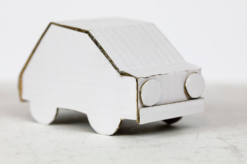 Car model made of white cardboard. Recycled packaging material has been used to handcraft this car model.