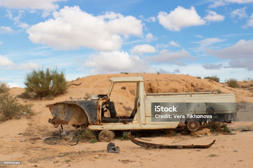 Rusty old wreck abandoned car in desert Rusty old wreck abandoned pickup car in Sahara desert, Tunisia Crash Stock Photo