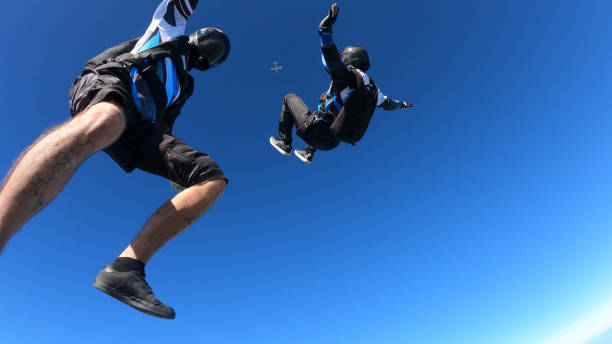 istock Skydivers fall through clear skies, aerial flight 1409905383