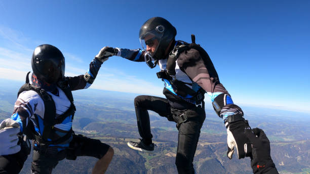 istock Skydivers fall through clear skies, aerial flight 1409905394