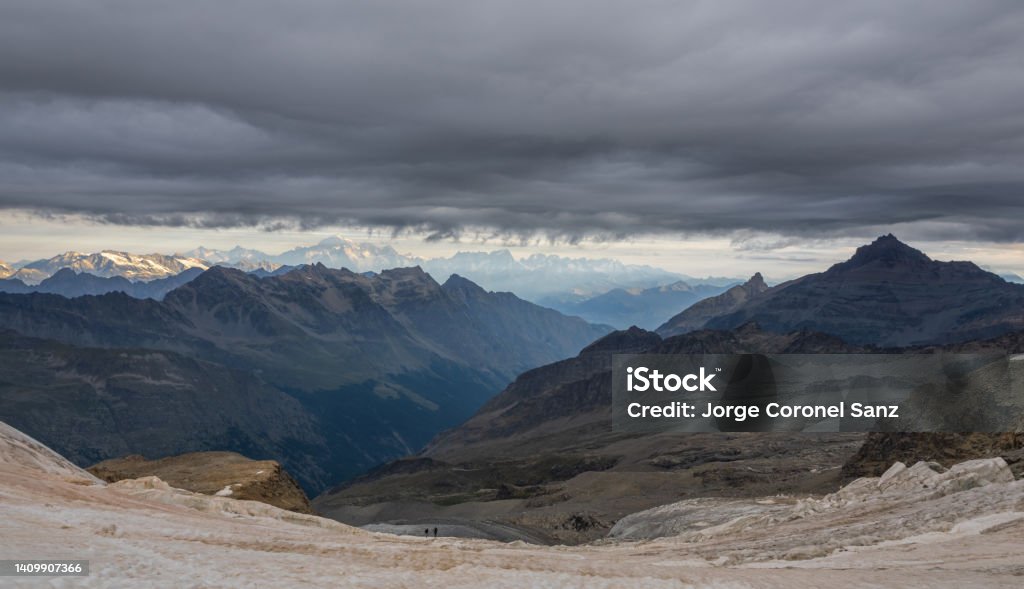 climbers descending the peak of Gran Paradiso chain of mountains in the alps from italy Adventure Stock Photo