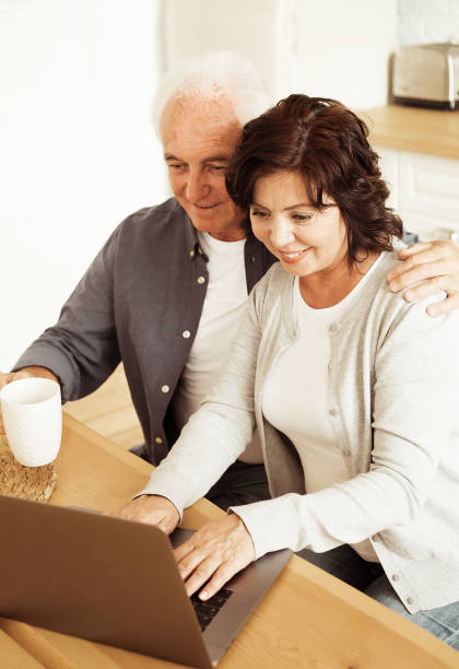 istock Elderly husband and wife using digital tablet at home, kitchen room 1409908382