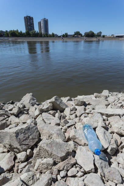 Water pollution, plastic waste on river bank