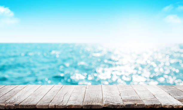 istock Empty wooden table or pier with sunny sea 1409913830
