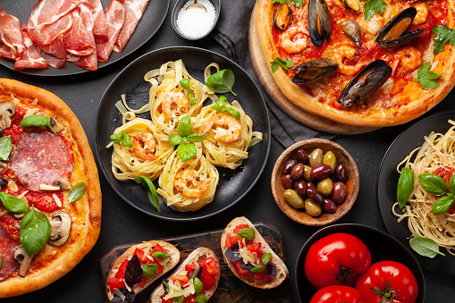 Italian cuisine. Pasta, pizza, olives and antipasto toasts. Flat lay