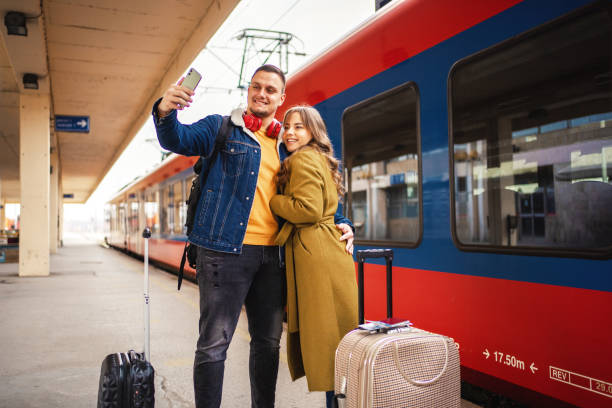 istock Young couple taking selfies while waiting on train station 1409914484
