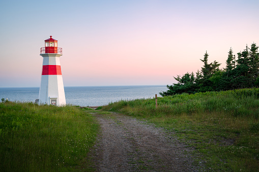 The beautiful Musquash head lighthouse at dusk, that overlook the coast over bay of fundy, St-John, New Brunswick, Canada