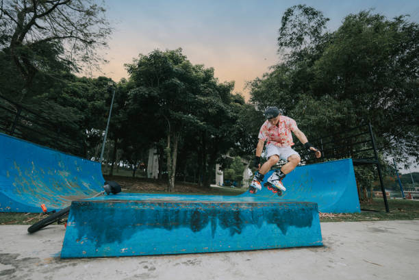 istock Asian Chinese mature Man practice inline skating at skateboard park during weekend jumping mid air 1409917346