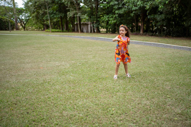 istock Little girl playing plastic disc in the grass 1409919281