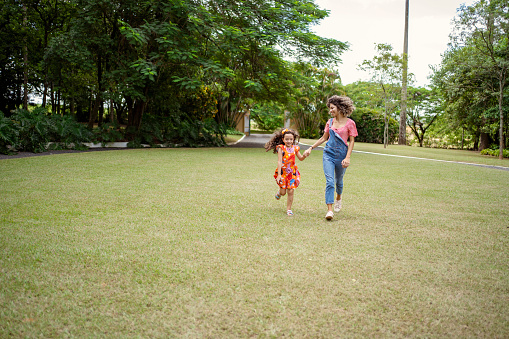 Teen age girls running in the grass