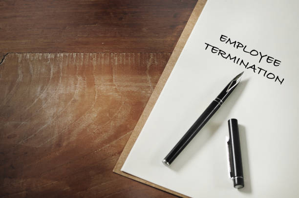 istock Employee termination words written on notebook on working desk 1409919374